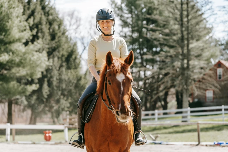 a woman is riding a horse at an equestrian competition