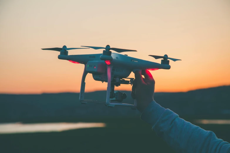 the person is holding a small remote controlled air plane