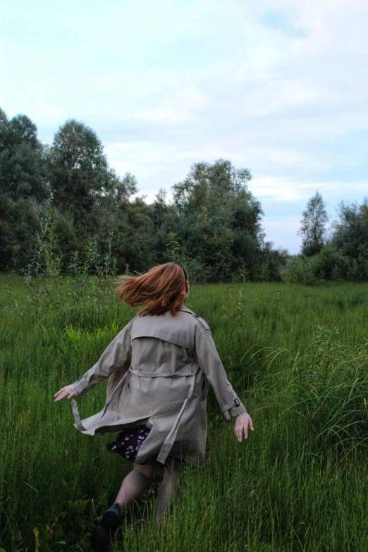 a person standing in a field with long hair