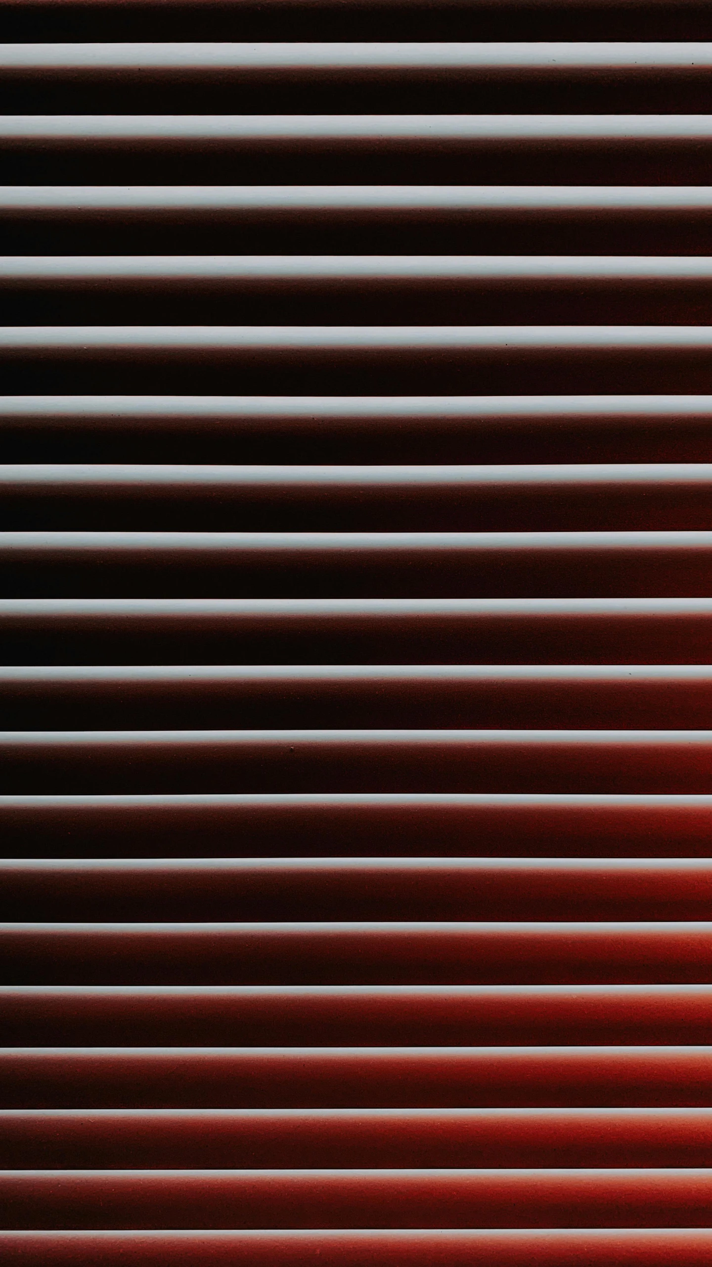 horizontal blinds made from red, pink and brown wood