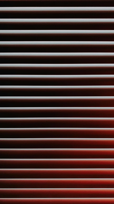 horizontal blinds made from red, pink and brown wood