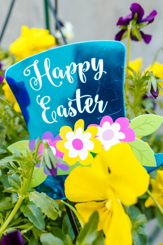 a large bush of flowers with an happy sign in the center