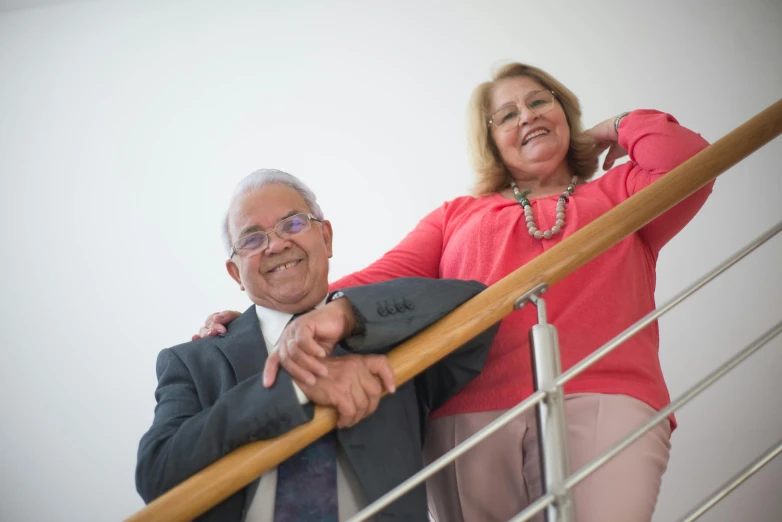 an older couple standing on a stair case together