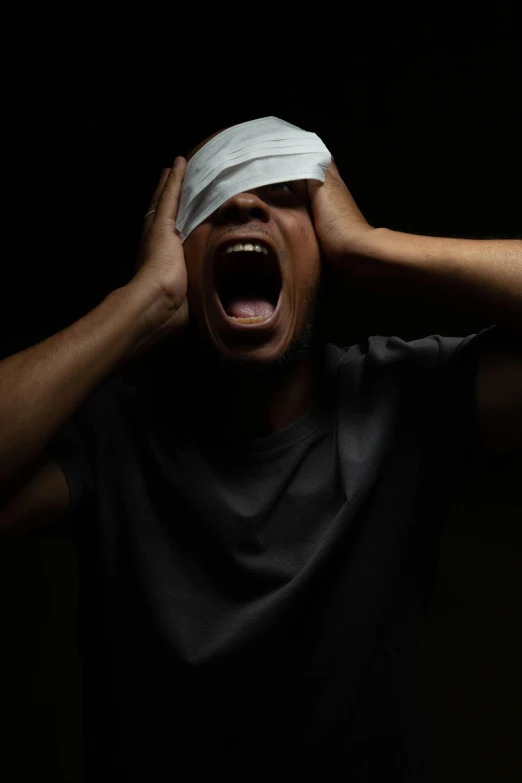 a man holding his head with an injured band