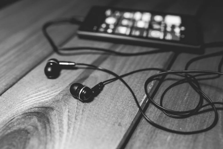 an mp3 player and earbuds are on a table