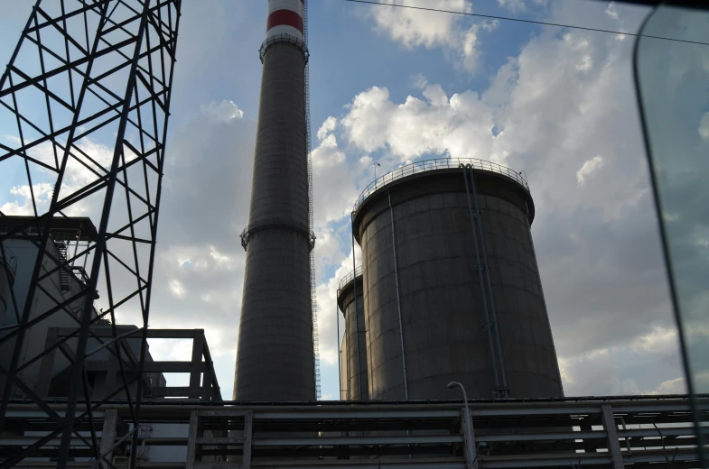 a tall smokestack sitting next to other smokestacks