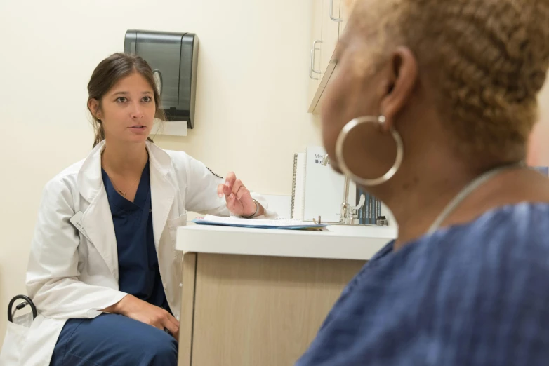 two doctors are discussing soing in a room