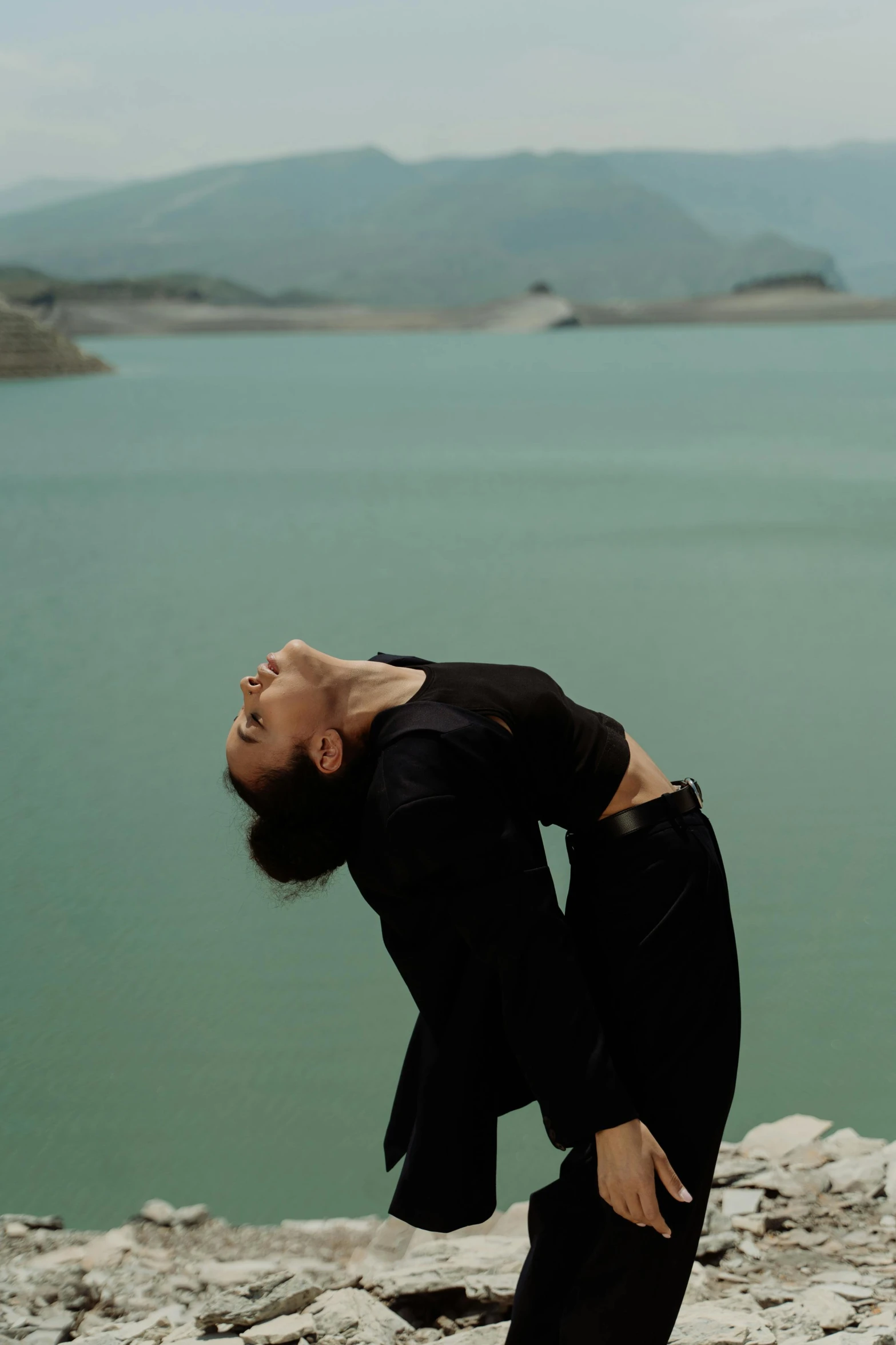 a man doing some kind of dance near water