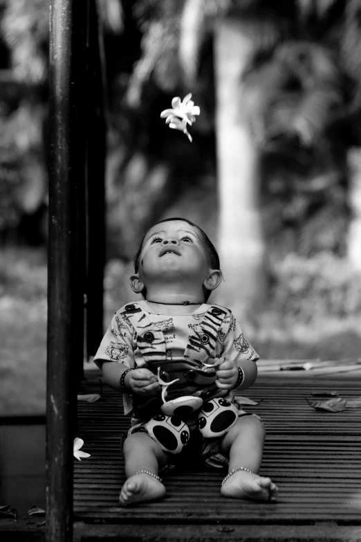 a little boy is sitting on a bench