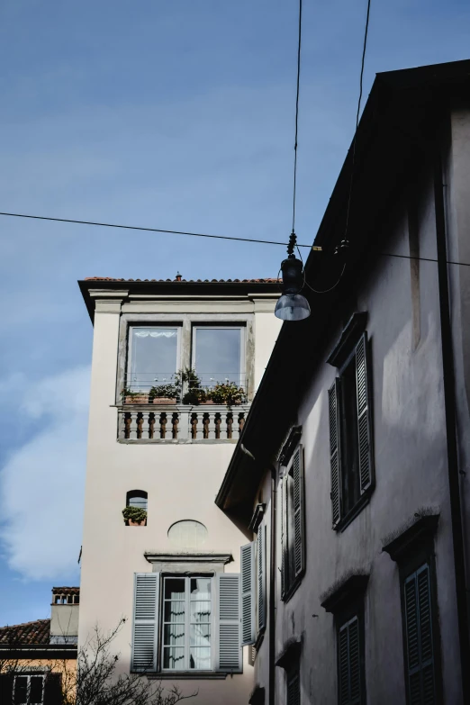 an apartment building with several windows and white shutters