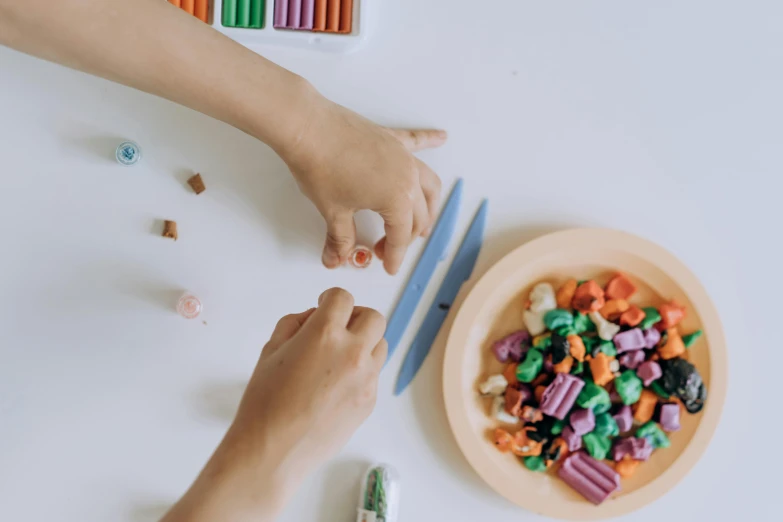 a 's hands and play with some colorful candy