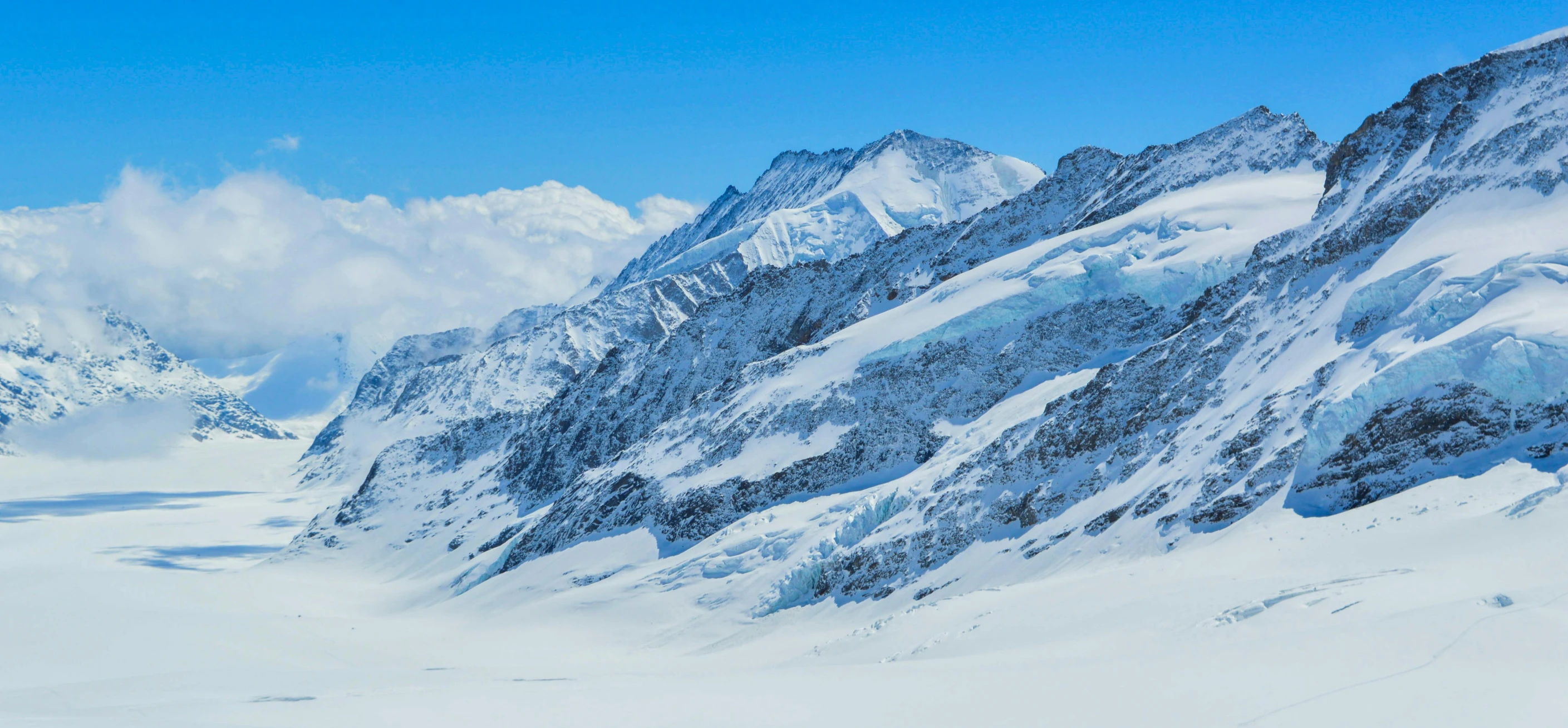 there is a mountain range covered in snow and ice