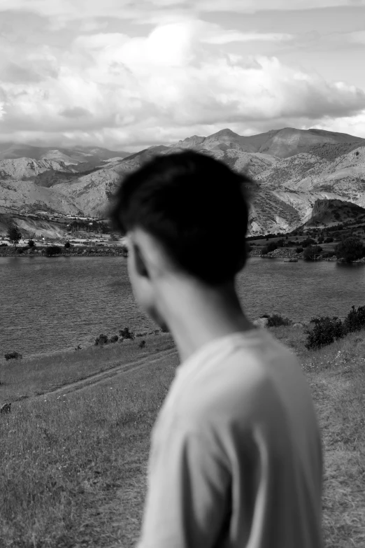 a man watching sheep graze on the grass