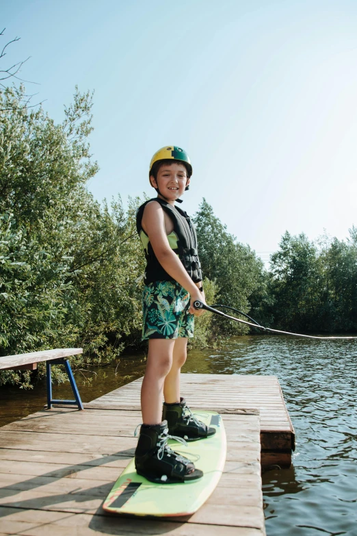 a  on a surfboard at a lake