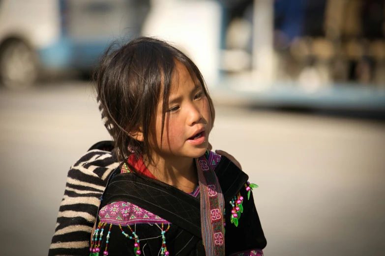 a  in colorful clothes standing by the street