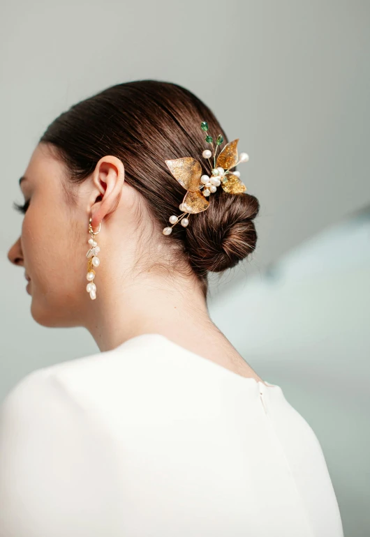 a woman wearing a hair comb with pearls