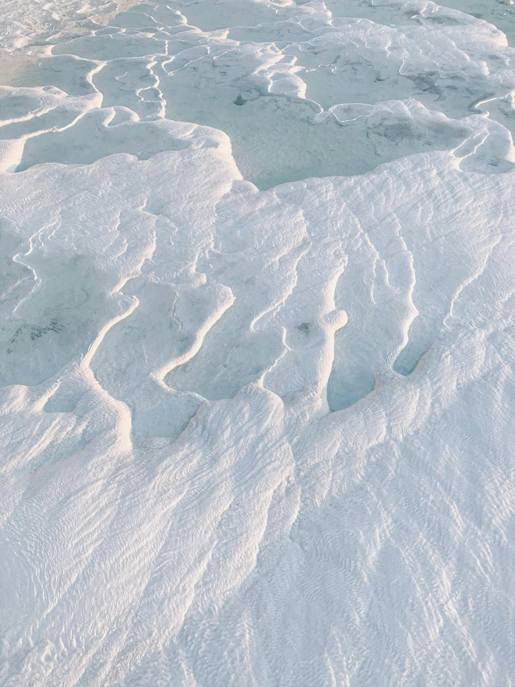 an airplane flying over a large glacier covered in snow