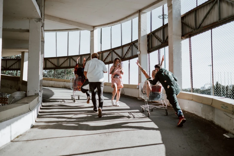 three people walking up a walkway in a building