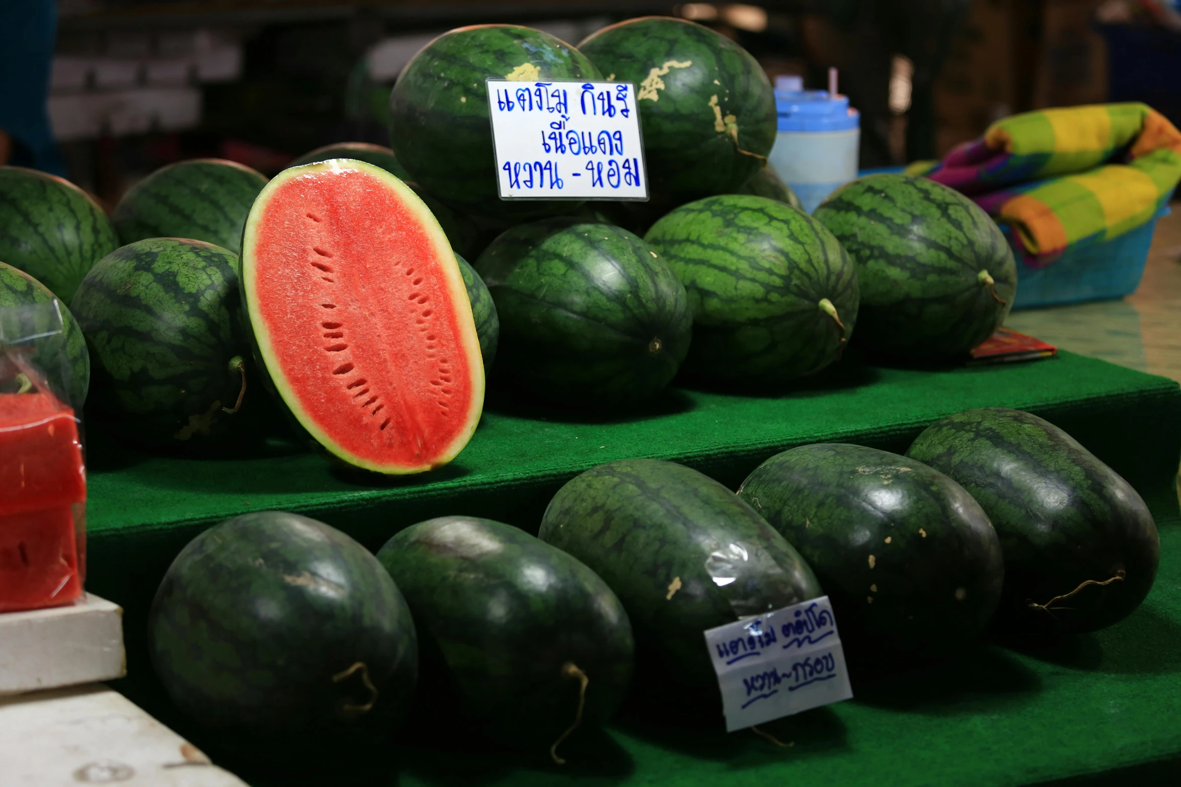 some fresh watermelons sitting next to each other