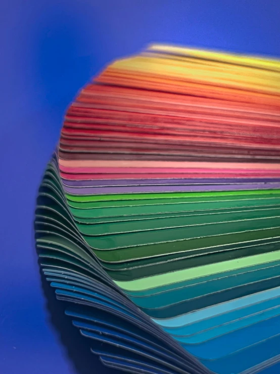 colorful sheets of paper folded neatly by hands