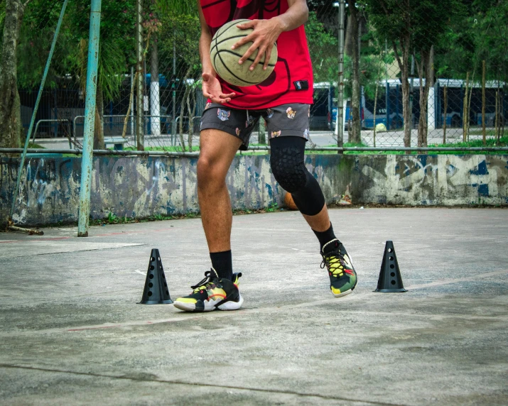 a basketball player with one foot on the ground in front of an obstacle set