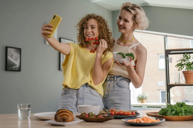 two women making faces as they prepare to eat