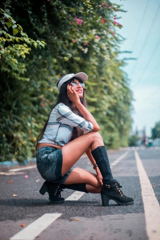 a woman sitting on the side of the road