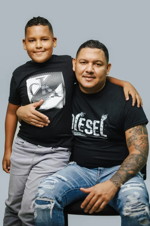 a man sits next to a child on his knees