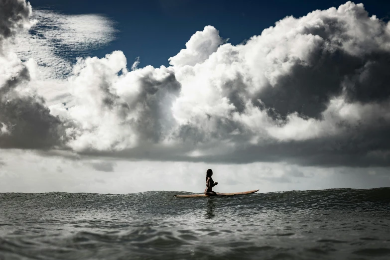 a person that is in the water with a surfboard