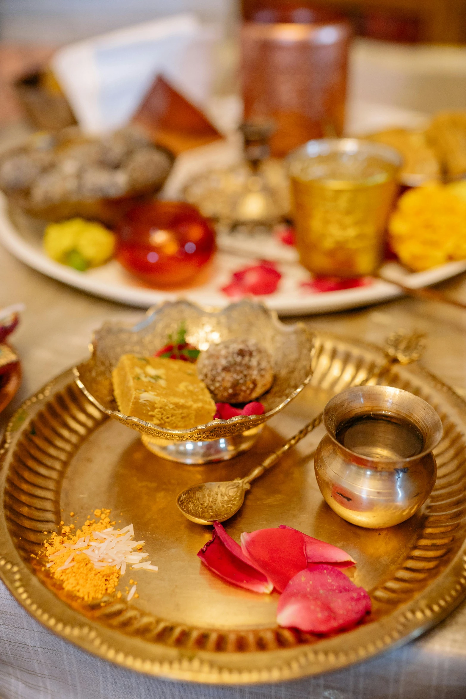 golden dishes and silver containers are all set up on a table