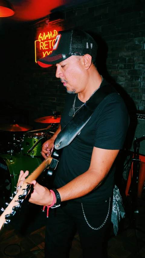 a man with guitar gear standing in a room