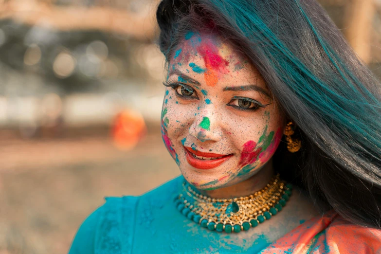 a young woman with many colors on her face and makeup