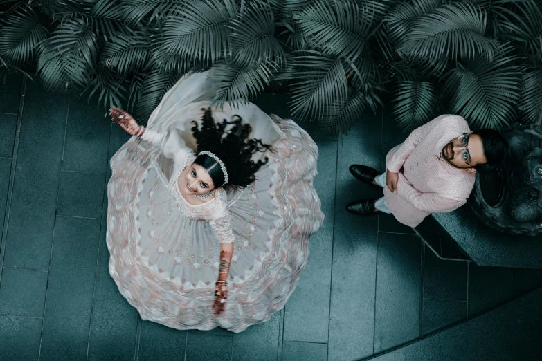 an aerial view of a bride and groom with an animal in their hand