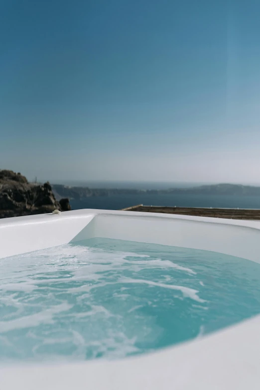 a large blue pool sitting on top of a white sandy beach