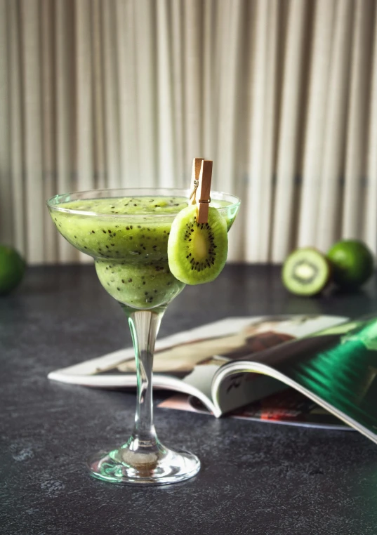 a lime and kiwi cocktail sitting on a table