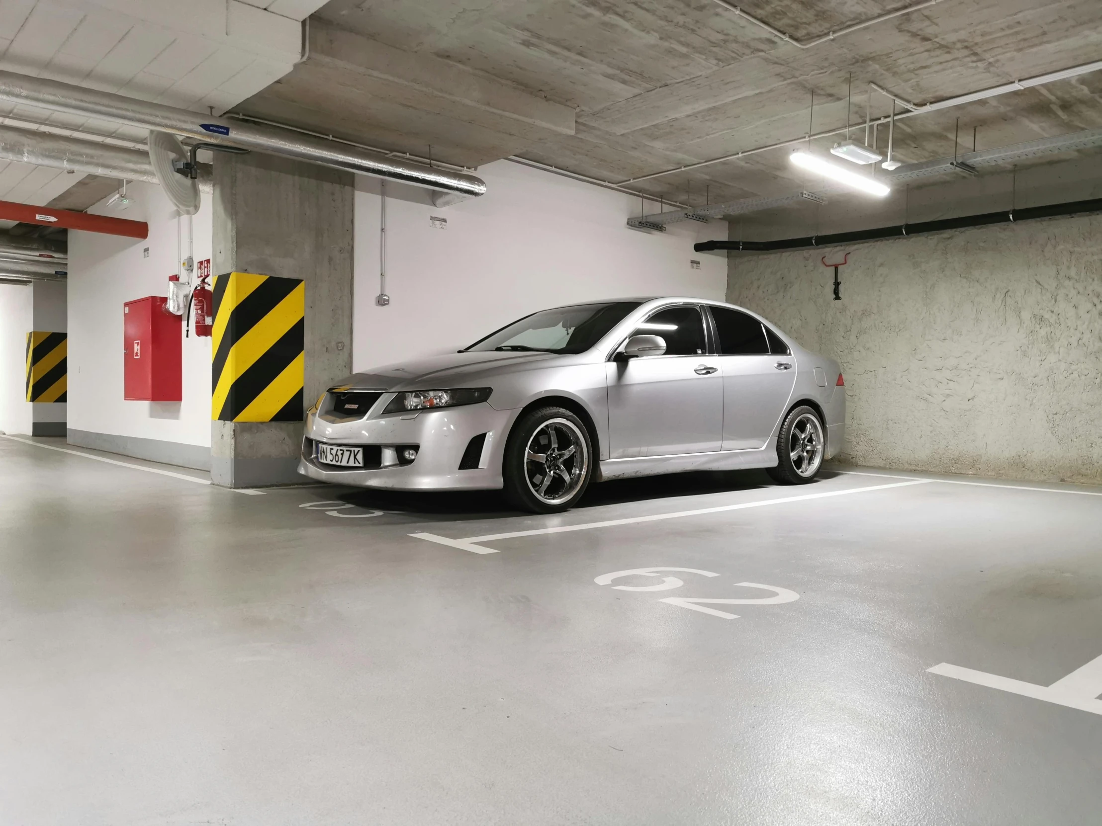 an open garage with a small white car