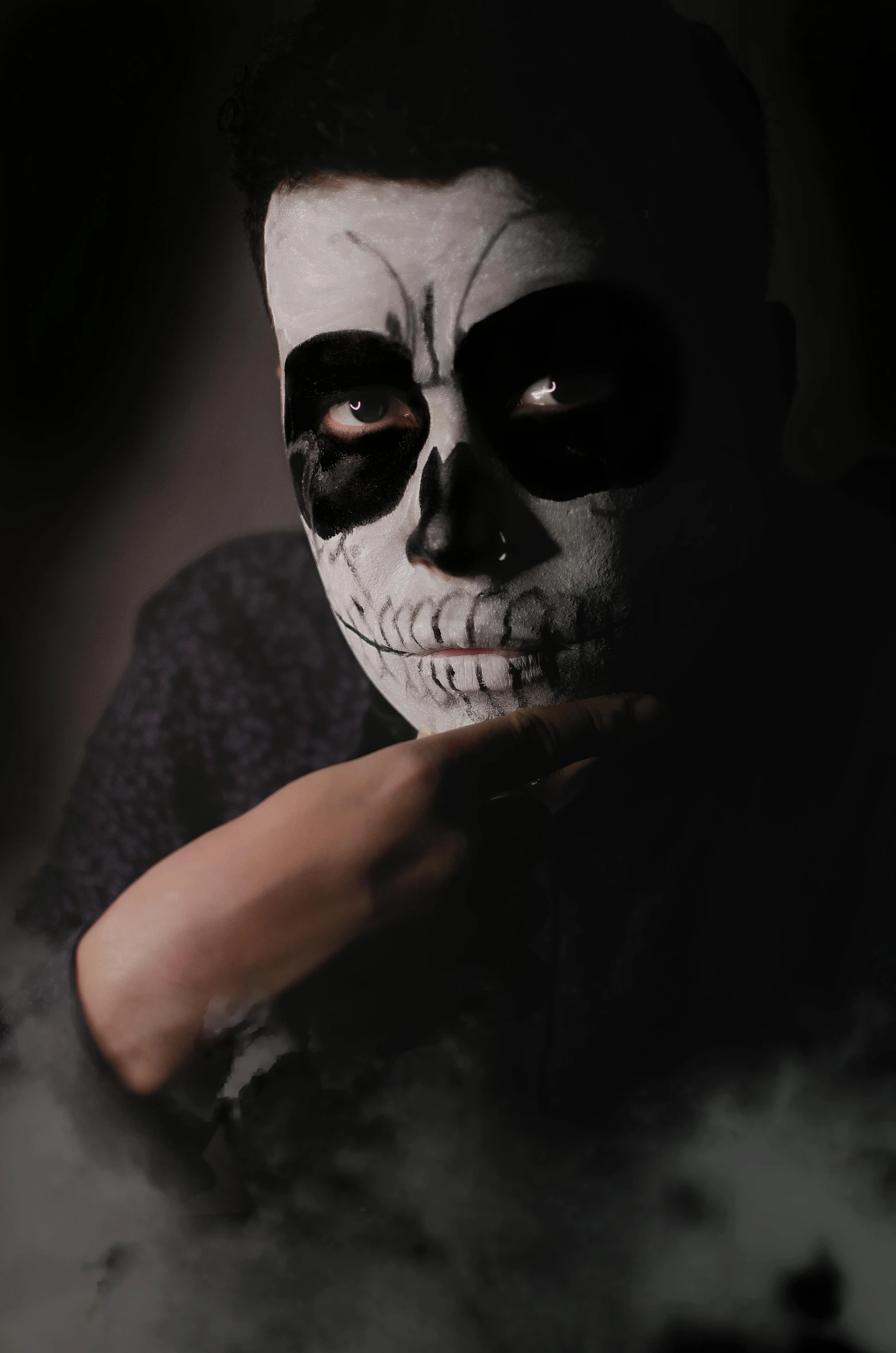 a man with a dark face painted like a skull