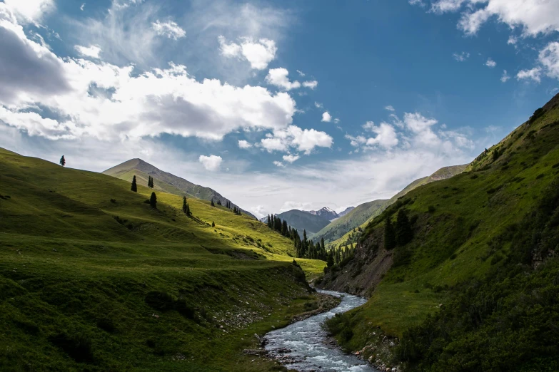 the mountains are surrounded by a river near trees