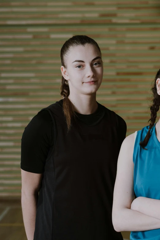 a man and woman standing next to each other in a gym