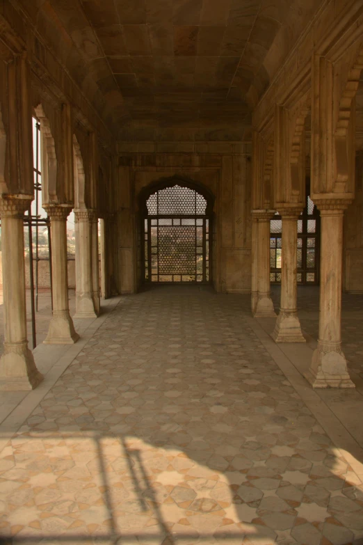 the inside of an old palace with marble pillars and arched windows