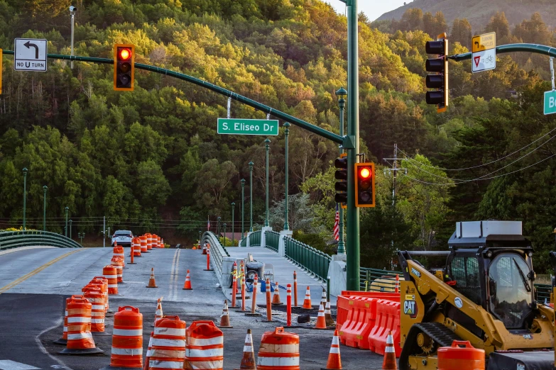 a road that is being paved up on one side with construction cones around it