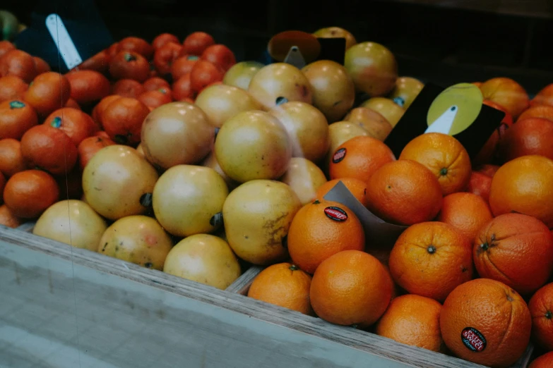 crates filled with lots of oranges and apples