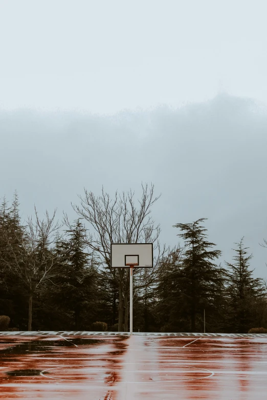 a basketball court on the side of an empty road