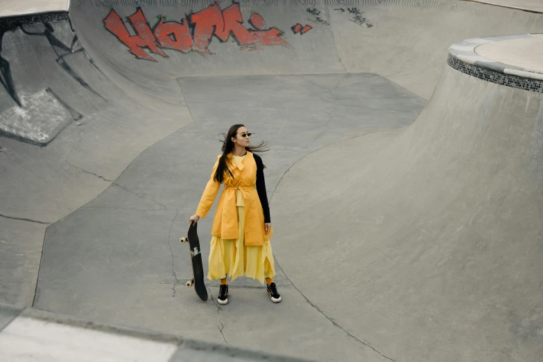 a skateboarder wearing yellow posing for a po