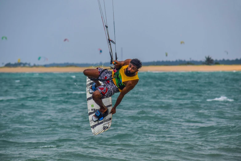 a man being pulled on to the beach with water skiis