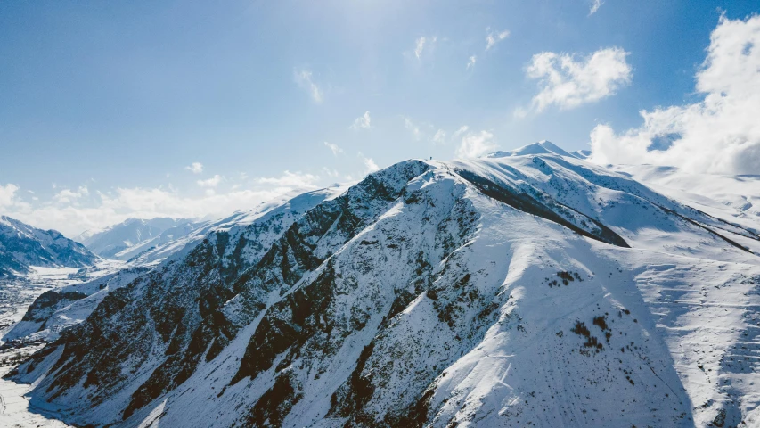 mountains covered in snow under a blue sky