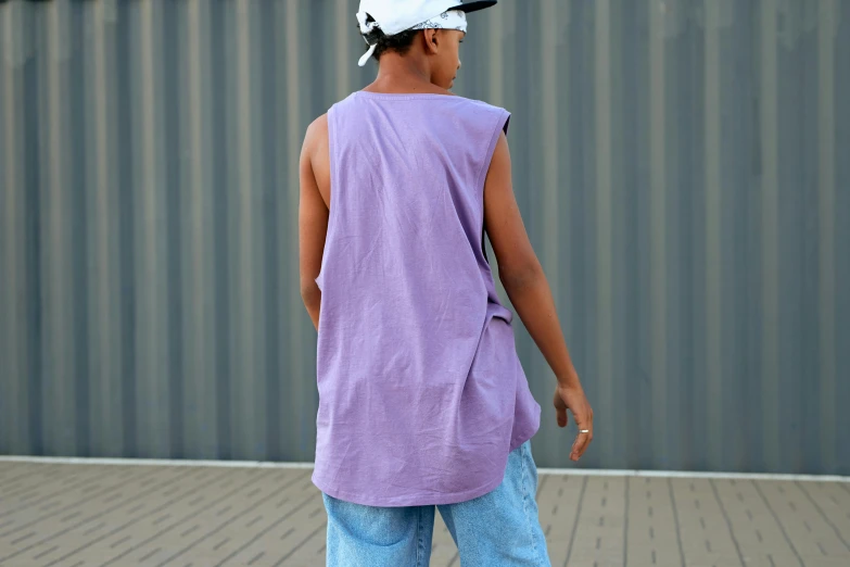 man in a hat is skateboarding outside near a building