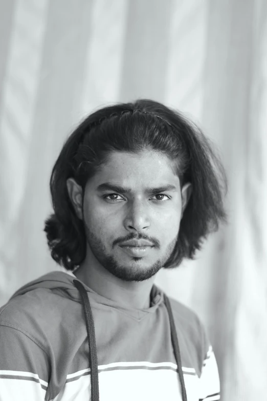 black and white po of a man with a large messy hair