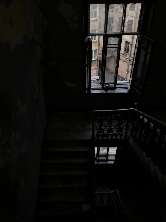 stairs leading down to an open window and door