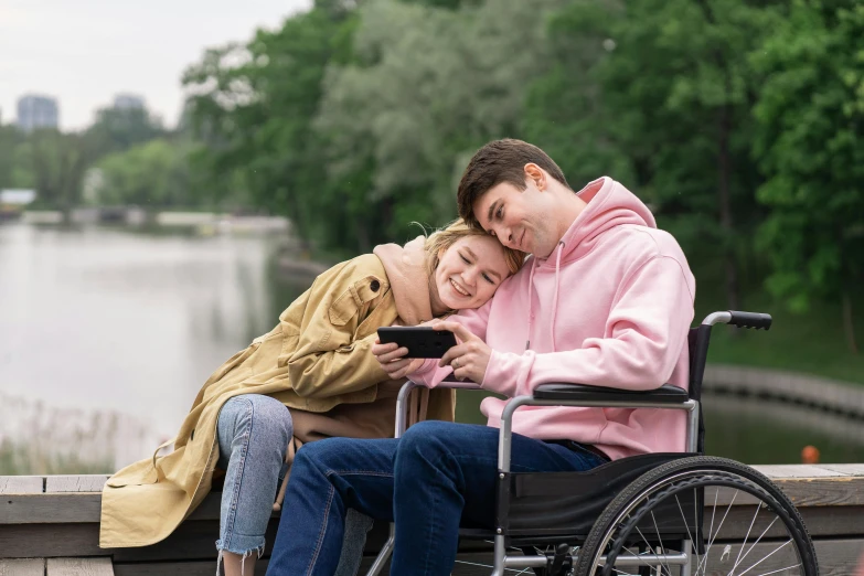 a man in a wheelchair sitting on top of a woman